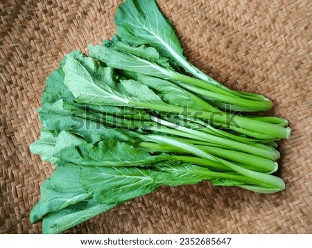 Fresh Choy Sum Vegetable (Brassica Rapa var. Parachinensis) on the Woven Bamboo Tray