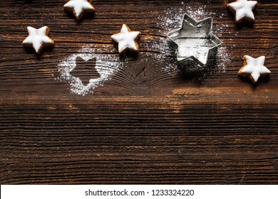Fresh cinnamon star shaped cookies with frosting on wooden table. - Powered by Shutterstock
