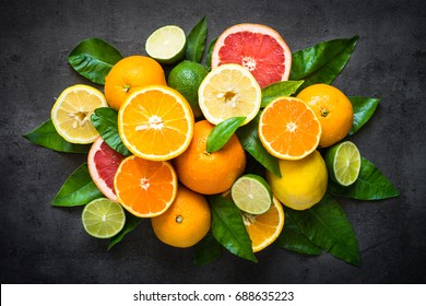 Fresh Citrus Fruit Assortment. Different Citrus Fruit On Black Slate Table. Fruit Food Background. Healthy Eating And Diet.