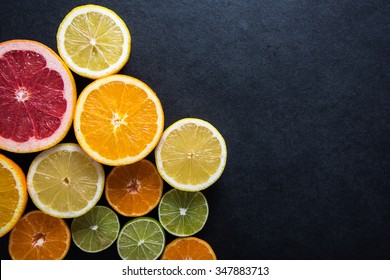 Fresh Citrus Fruits Half Cut, Dark Border Background With Copy Space,from Above