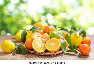 fresh citrus fruits with leaves on a wooden table - Shutterstock ID 2200488113