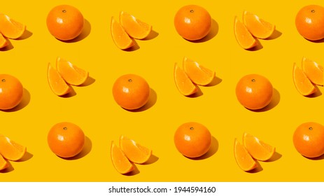 Fresh citrus Seamles fine pattern. Ripe fruit tangerines. Trendy sunlight Summer pattern made with mandarine slice on bright light orange background. Minimal summer concept. Monochromatic Banner.