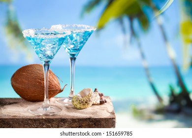 Fresh Cocktail With Blue Curacao On Beach Background