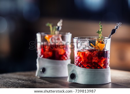 Fresh cocktail drink with ice fruit and herb decoration. Alcoholic, non-alcoholic drink-beverage at the bar counter in the pub restaurant  or night club.
