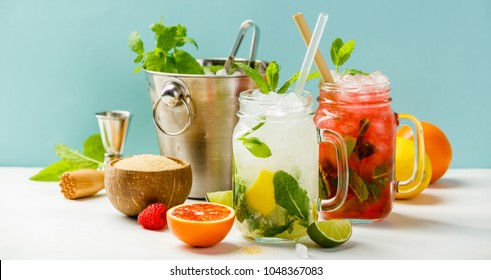 Fresh cocktail drinks with ice fruit and herb decoration. Alcoholic non-alcoholic drink-beverage. Mojito on blue background - Shutterstock ID 1048367083