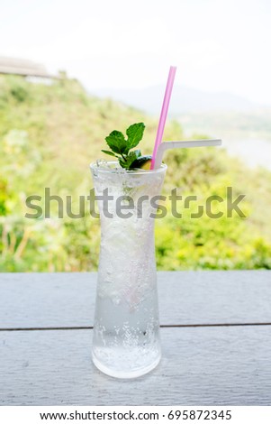 Fresh cocktail with lime slice on table