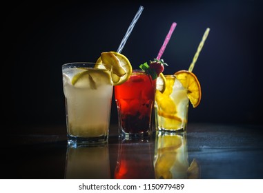 Fresh cocktail on a black background. Alcoholic cocktail on a black background. Fruit with a cocktail. Non-alcoholic cocktail. Mix of cocktails on a black background. - Shutterstock ID 1150979489