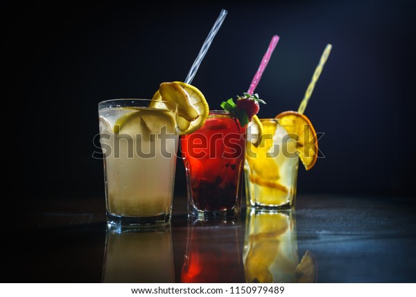 Fresh cocktail on a\
black background. Alcoholic cocktail on a black background. Fruit\
with a cocktail. Non-alcoholic cocktail. Mix of cocktails on a\
black background.
