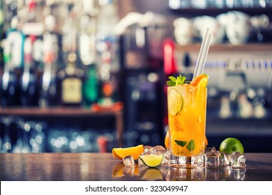 Fresh cocktail with orange, limet, mint and ice. Alcoholic, non-alcoholic drink-beverage at the bar counter in the night club. - Shutterstock ID 323049947