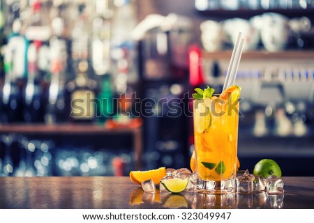 Fresh cocktail with orange, limet, mint and ice. Alcoholic, non-alcoholic drink-beverage at the bar counter in the night club.