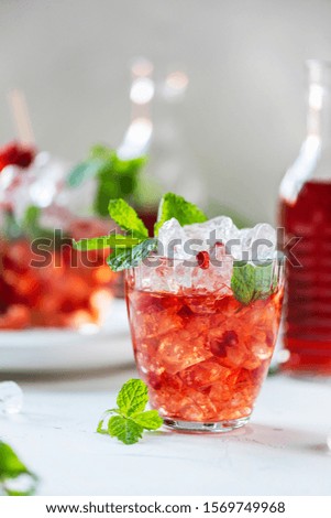 Fresh cocktail with pomegranate, mint and ice, selective focus image