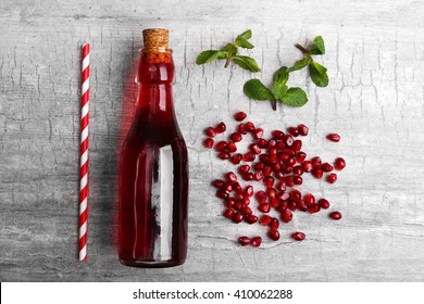 Fresh Cocktail Preparation: Soda Bottle, Pomegranate, Straw  On Grey Table Background, Top View