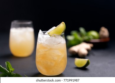 Fresh cocktail prepared with ginger beer, lime and ice. Beverage on the table