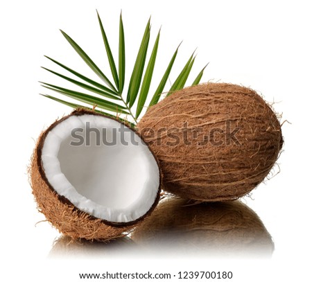 Fresh coconut broken in half with leaves isolated on white background