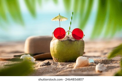 Fresh Coconut juice with tropical beach view, Summer cool drink concept image, Tender coconut juice with red sunglass and hat on the background - Powered by Shutterstock