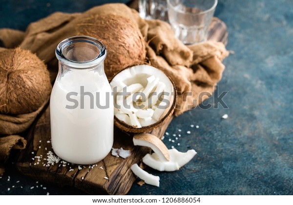 Fresh coconut milk in glass bottle, vegan non dairy\
healthy drink