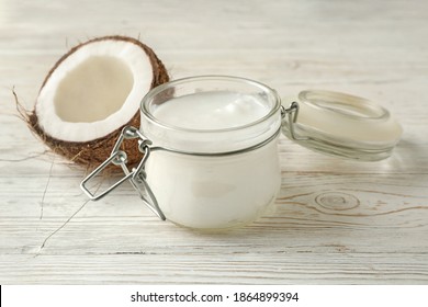 Fresh coconut and coconut milk on wooden background - Shutterstock ID 1864899394