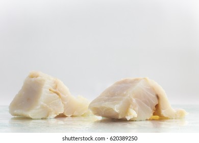 Fresh Cod Fish Fillet Over A Wet Glass Surface