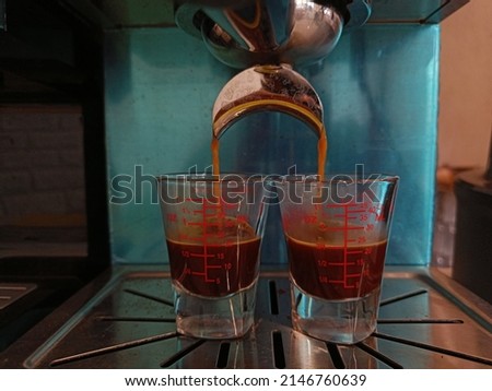 Fresh coffee dripping into a cup from professional coffeemaker.