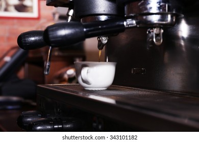 Fresh coffee making in the professional coffee machine, close up - Shutterstock ID 343101182