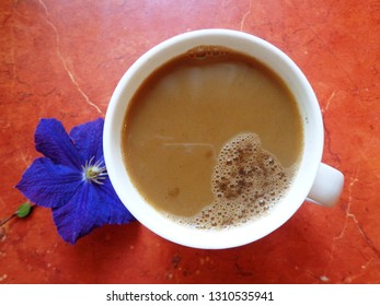 
	Fresh coffee and purple flower				