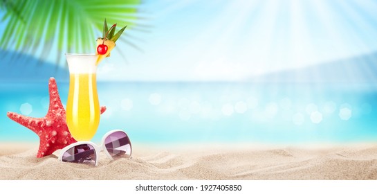 Fresh cold cocktail on tropical beach with palms and bright sand. Summer sea vacation and travel concept with copy space
