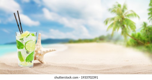 Fresh cold cocktail on tropical beach with palms and bright sand. Summer sea vacation and travel concept with copy space - Powered by Shutterstock