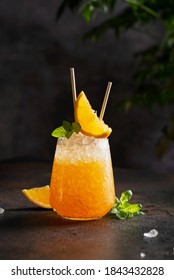 Fresh cold cocktial with orange, crushed ice and mint, selective focus image and bar concept