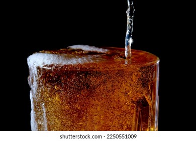 Fresh cold light barley beer is poured into a glass glass on a black background close-up - Powered by Shutterstock