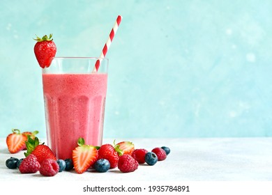 Fresh Cold Strawberry Berry Smoothie In A Tall Glass On A Light Blue Slate, Stone Or Concrete Background.