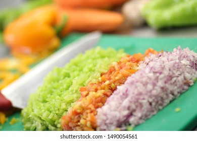 Fresh colorful vegetables cut into small pieces ready for cooking or to prepare a delicious vegan salad.
