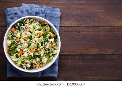 Fresh Cooked Brown Rice With Steamed Vegetables (broccoli, Cauliflower, Swiss Chard, Carrot, Celery) In Bowl, Photographed Overhead With Copy Space On The Right Side 