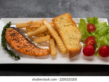 Fresh Cooked Delicious Salmon Steak With French Fries And Toast Bread. 