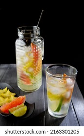 Fresh Cool Lemon Grapefruit And Star Fruit Infused Water, Cocktail, Infused Drink, Lemonade In A Glass Bottle For Spring Summer Days. 
Pitcher Of Flavored Water And Fruit Plate (grapefruit, Lemon And 