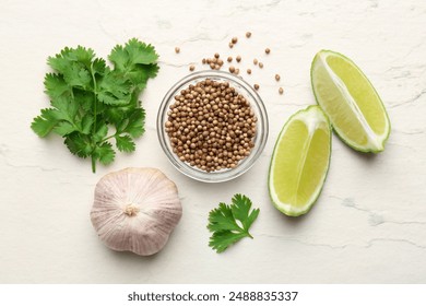 Fresh coriander leaves, dried seeds, garlic and lime wedges on light textured table, flat lay - Powered by Shutterstock