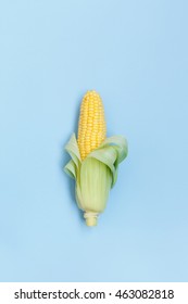 Fresh Corn On The Cob On A Blue Background Overhead Shot