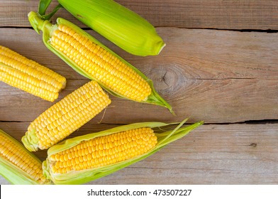 Fresh Corn,Fresh Corn On Cobs On Wooden Table, Closeup,  Top View