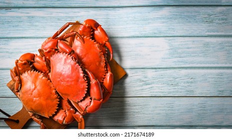 fresh crab on wooden cutting board, seafood crab cooking food boiled or steamed crab red in the seafood restaurant - top view 