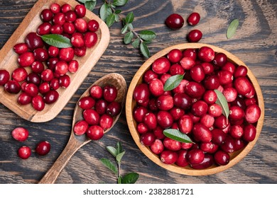 Fresh cranberries in a wooden bowl with spoon on dark wooden table. View from above. - Powered by Shutterstock