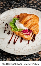 fresh croissant with poached eggg and bacon