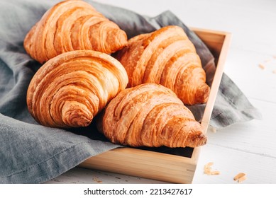 Fresh croissants, jam and coffee on white wooden table. Close up. - Powered by Shutterstock