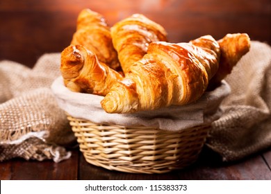 fresh croissants on wooden table - Powered by Shutterstock