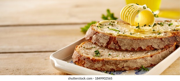 Fresh Crusty Buttered Rye Bread Slices Sprinkled With Chopped Parsley And Garnished With A Butter Curl