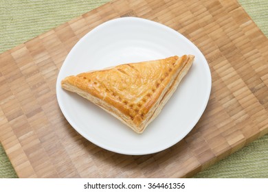 Fresh curry chicken pie on white plain dish in brown wooden texture background - Shutterstock ID 364461356