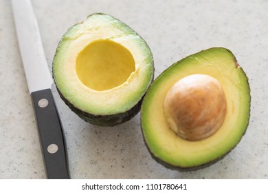 Fresh Cut Avocado on Wooden Cutting Board. - Shutterstock ID 1101780641