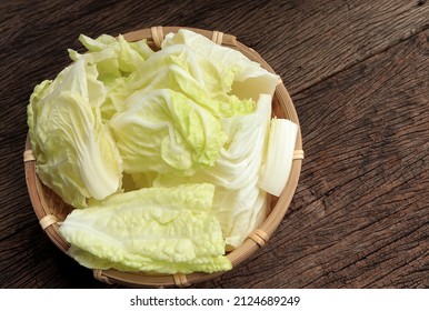 Fresh Cut Chinese Cabbage, Napa Cabbage Or Bok Choy In Basket On Old Wooden Background. 