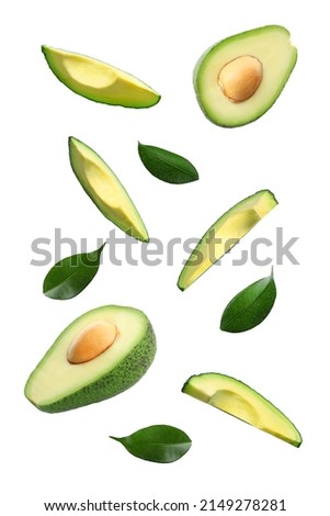 Fresh cut flying avocados isolated on white