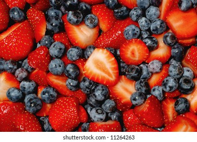 Fresh Cut Strawberries And Blueberries Piled Up High