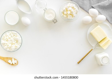 Fresh dairy products for breakfast with milk, cottage, eggs, butter, yougurt on white background top view mock up - Shutterstock ID 1455180800