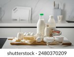Fresh dairy products, milk, cottage cheese, eggs, yogurt, sour cream and butter on kitchen table